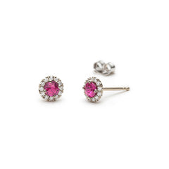 Round cut hot pink sapphire diamond halo stud earrings in white gold.