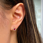 Lepi Mermaid Scale Motif Pear-Shaped Ruby Stud Earrings on a Model