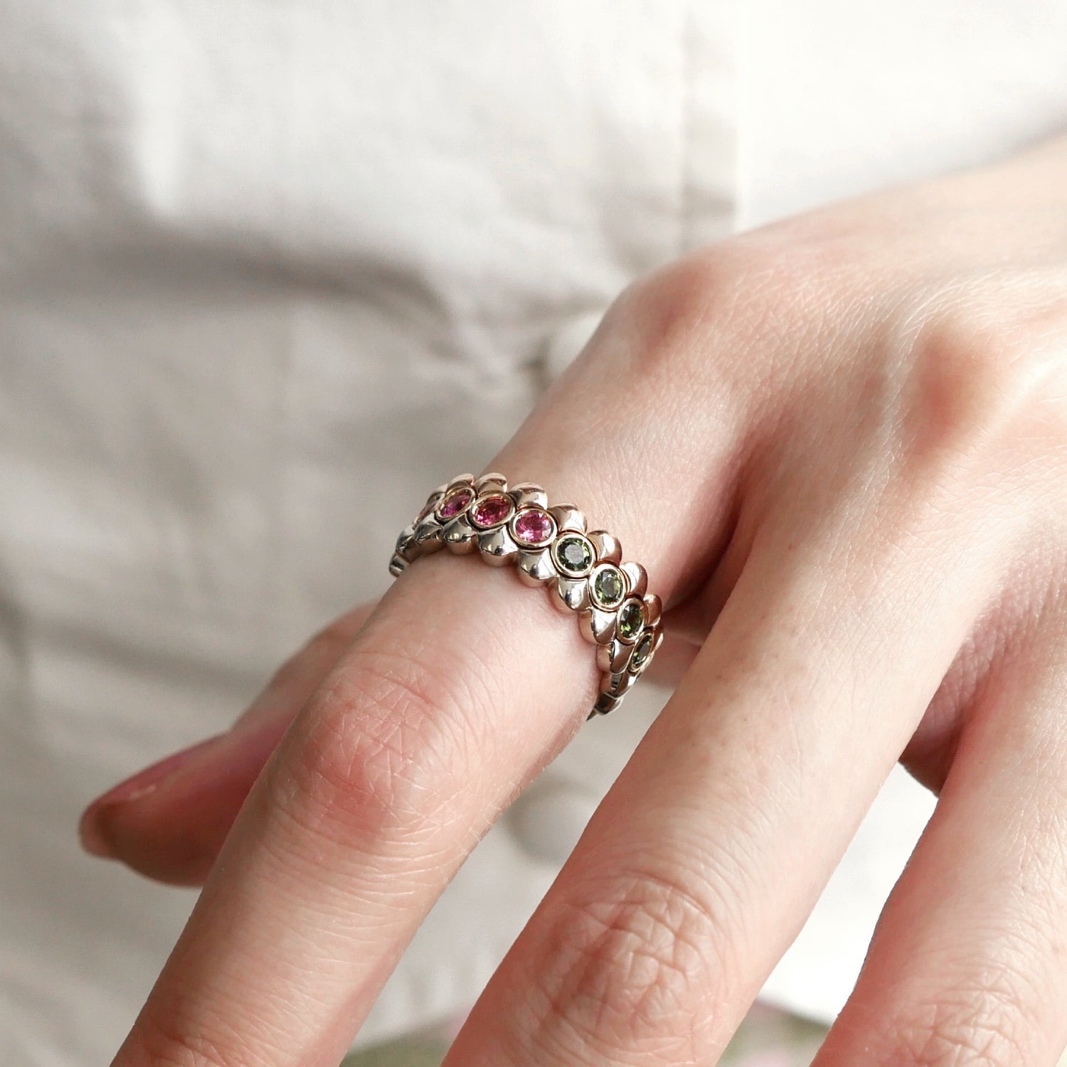 Mermaid Pink and Green Tourmaline Eternity Ring on a Hand